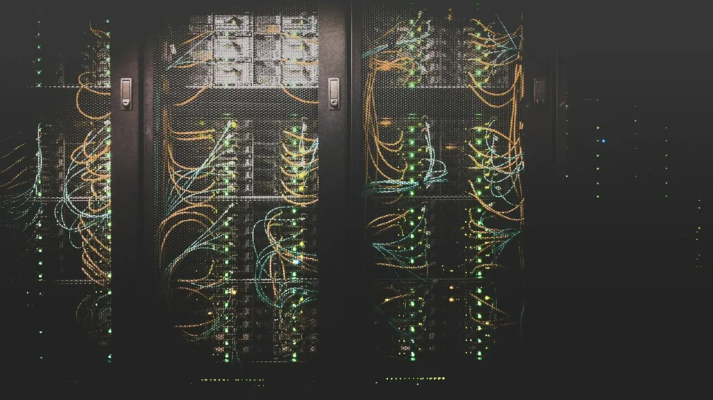 Business network upgrade: server racks with network patch cables and status LEDs at a Long Island office.