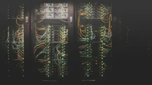 Business network upgrade: server racks with network patch cables and status LEDs at a Long Island office.